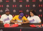 Nate Burns IV, center, signs a letter of intent at the Mexia High School gym Wednesday morning to play football at the Unviersity of Mary-Hardin Baylor in Belton. He is flanked by his parents, Nathaniel Burns III, left, and Bonnie Burns, right.